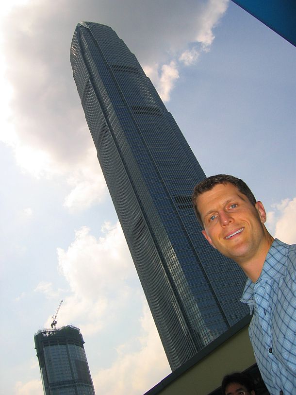 Brooks standing below the world famous Bullet building Hong Kong Architecture from the Street